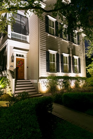 Front of home with trees and landscape lighting